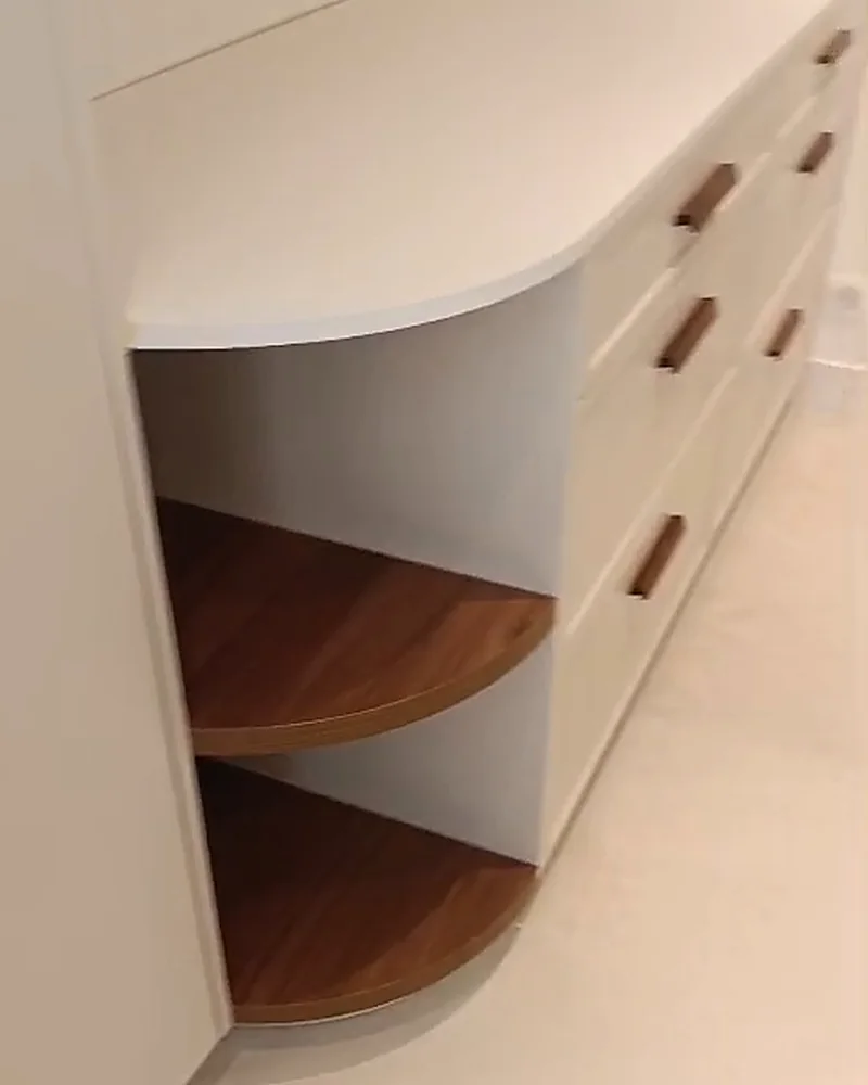 Meuble sur mesure crème à angle courbe et tiroirs noyer